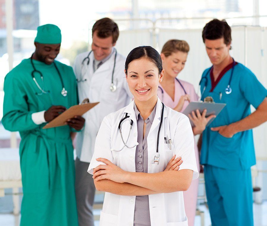 A team of physicians and nurses reviewing patient notes together