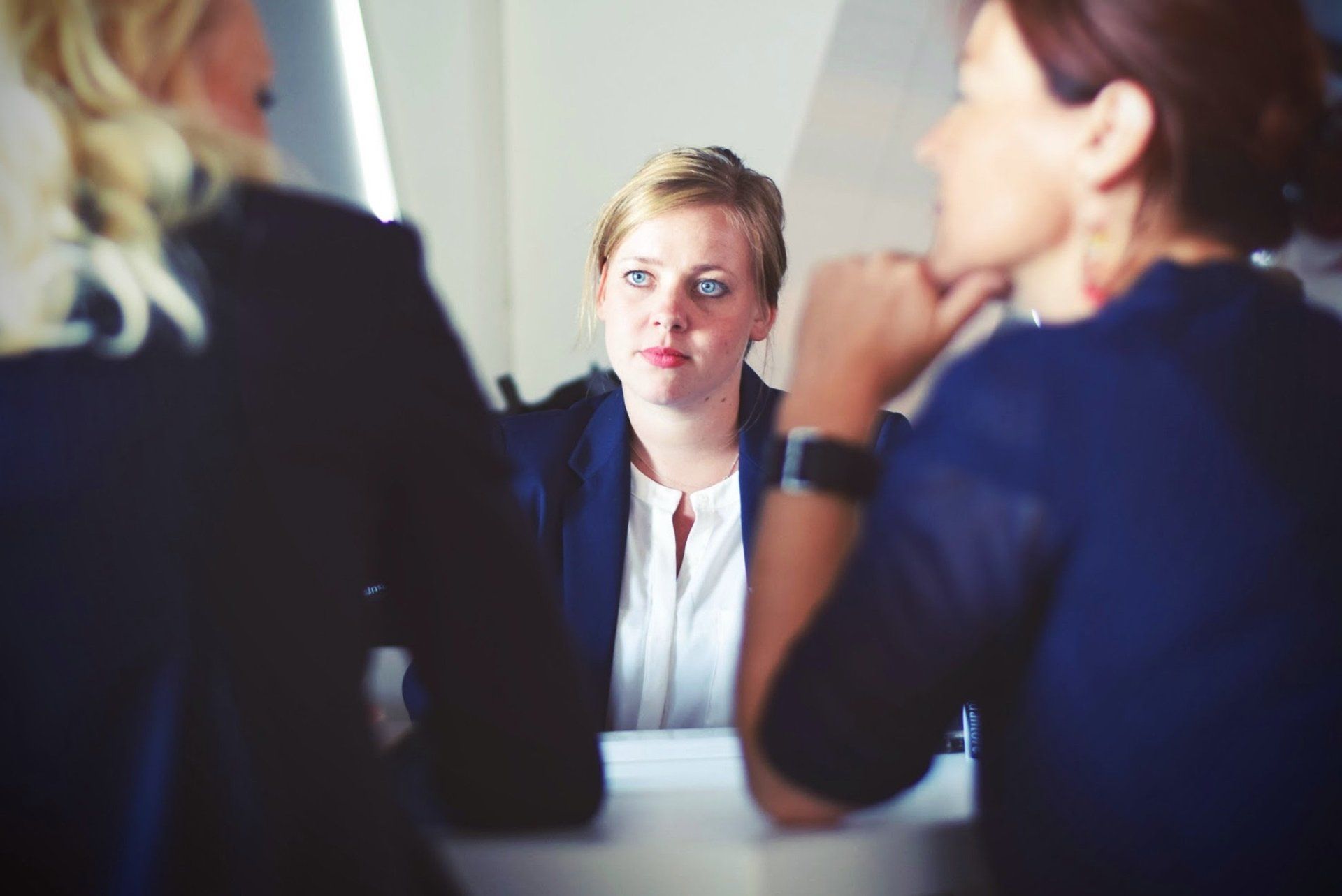 An HR professional listening attentively during an employee feedback meeting